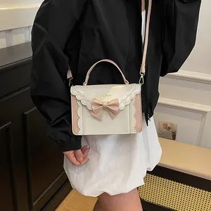 Sweet bow accordion crossbody bag in pink and white with elegant wavy edge design