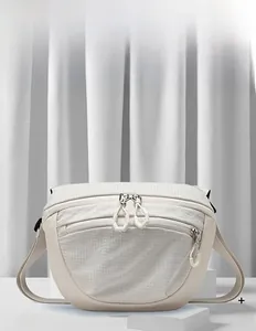 Detail of waterproof nylon hip backpack with grid texture and dual zipper compartments