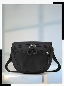 Detail of black crossbody bag featuring ripstop grid texture and dual zipper pulls