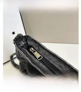 Detailed close-up of premium metal zipper and durable denim fabric on a tote bag