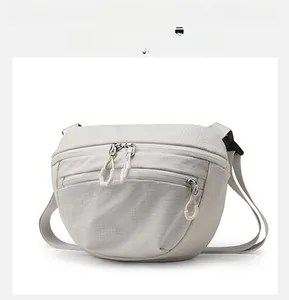 Detail view of water-resistant light grey crossbody bag with ripstop textured fabric