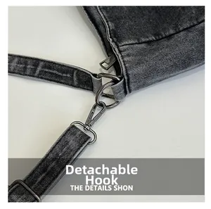 Detail of dark denim tote bag featuring brushed metal detachable hook and D-ring hardware