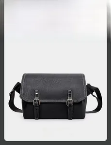 Detailed front view of black PU leather messenger bag with white contrast stitching