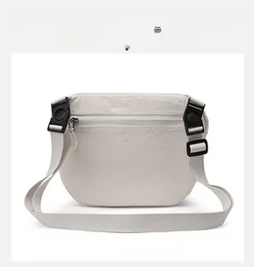 Detailed back view of a beige nylon crossbody bag with a zippered pocket and adjustable strap