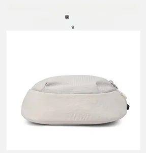 Detail view showing the reinforced bottom and ripstop fabric of the beige crossbody bag