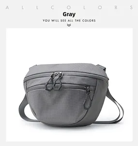 Detailed macro view of gray ripstop nylon crossbody bag with dual zipper pullers