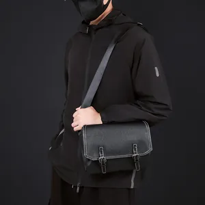 Detailed view of black PU leather messenger bag with white stitching and buckles