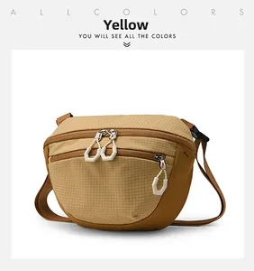 Detail of water-resistant yellow crossbody bag showing mesh nylon and zip pullers