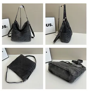 Detail view of black denim tote bag showing pockets, stitching and adjustable strap