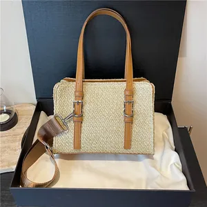 Natural straw handbag with brown leather straps in a premium gift box presentation