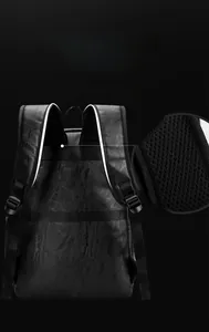 Detail view of honeycomb breathable mesh shoulder straps on a black leather backpack