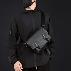 Detail of black faux leather messenger bag showing white contrast stitching and buckles