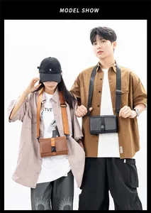 Detailed view of leather box crossbody bags in brown and black with buckle closure