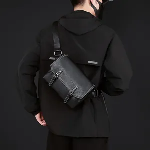 Detail of black PU messenger bag with contrast stitching and metallic buckle straps