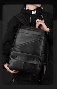 Detail of black faux leather backpack featuring textured finish and sleek silver rivets