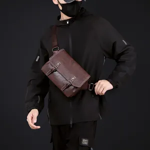 Close-up of brown PU leather crossbody bag featuring white stitching and buckle details