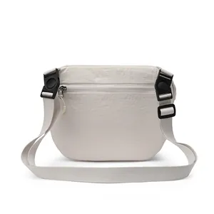 Waterproof cream nylon crossbody bag with adjustable wide strap and arc shape for outdoor travel