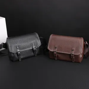 Detail of PU leather messenger bags in black and brown with contrast stitching