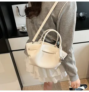 Modern white tote bag with wing-shaped design shown as a crossbody on a model back view