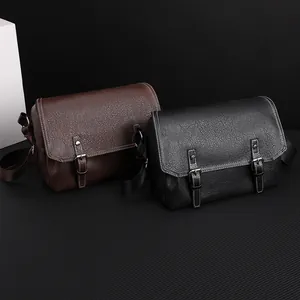 Detail of vintage PU leather messenger bags in black and brown with white stitching