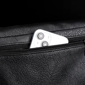 Close-up of waterproof PU leather messenger bag with phone stored in back zipper pocket