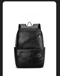 Front view of black faux leather backpack showing litchi texture and zip pockets