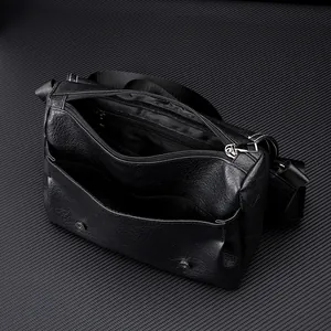 Detail view of black PU leather crossbody bag showing inner compartments and pockets