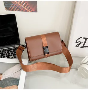 Detailed macro view of brown PU leather bag with black buckle and stylish woven strap
