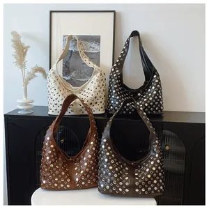 Detail of studded tote bags in four colors with eyelet rivets and wide shoulder straps