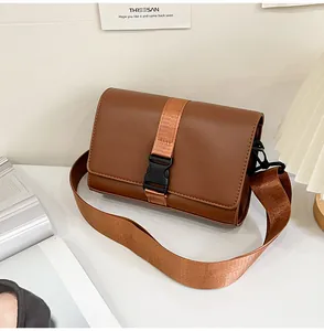 Detailed view of brown PU leather box bag with matte finish and black buckle closure