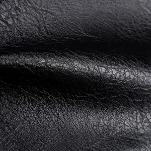 Close-up of black PU leather texture with detailed pebble grain and matte finish