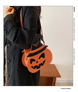 Detail of pumpkin crossbody bag with black wizard hat and bat embroidery on person