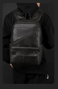Close-up of premium black lychee-textured leather backpack with metallic zipper details