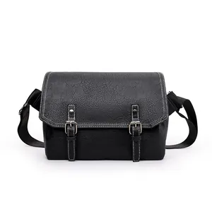 Waterproof PU leather black messenger bag with vintage white stitching and buckle detail