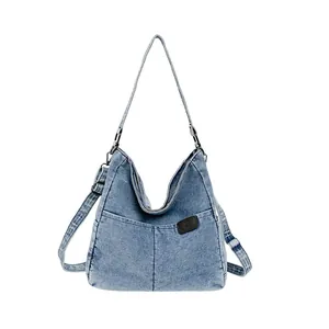 Large capacity denim tote bag with adjustable strap and front pocket in light blue