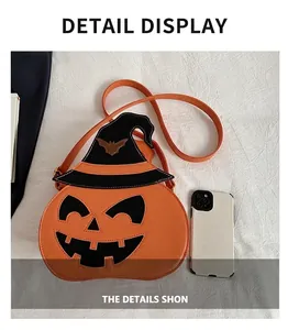 Detailed comparison of orange pumpkin crossbody bag and smartphone for size reference
