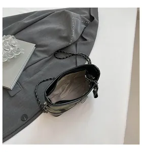 Detail of a quilted chain bag showing inner lining, pocket, and zipper closure
