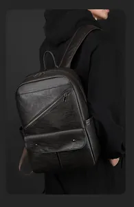 Close-up of black leather backpack showing the premium pebble texture and metal buckle detail