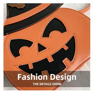 Detailed view of pumpkin-shaped crossbody bag with black bat patch and fine stitching
