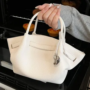 White lychee leather hobo bag with unique semi-moon structure and silver charm