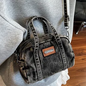 Vintage distressed denim boston handbag with leather patch and adjustable strap