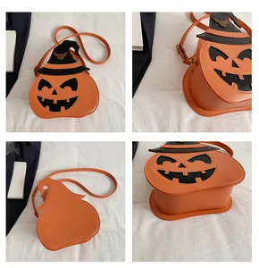 Detail view of pumpkin crossbody bag with wizard hat and golden bat decoration