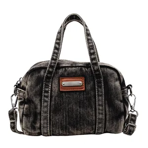 Retro washed denim handbag with adjustable shoulder strap and silver metal hardware details