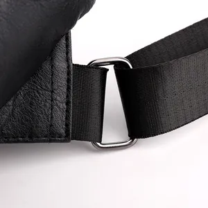 Detail of waterproof black PU leather messenger bag with metal buckle and shoulder strap