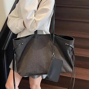 Minimalist large black tote bag with textured wool felt finish and matching pouch