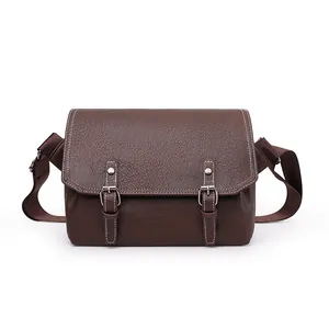 Brown PU leather messenger bag with pebble texture and white stitching details
