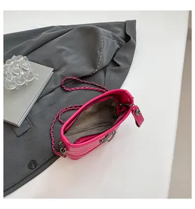 Macro shot of rose red crocodile pattern bucket bag with silver chain and inner zipper pocket
