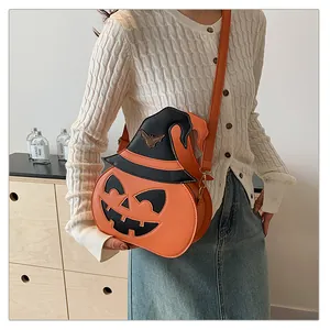 Detail of Halloween pumpkin crossbody bag with wizard hat and bat charm for women