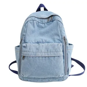 Sac à dos rétro en toile denim bleu clair avec poche zippée et bretelles bleu foncé