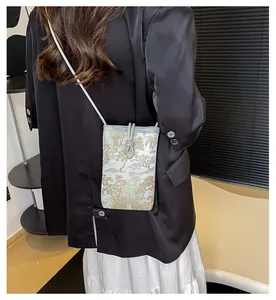 Detailed view of grey oriental jacquard crossbody phone bag with pavilion tree pattern